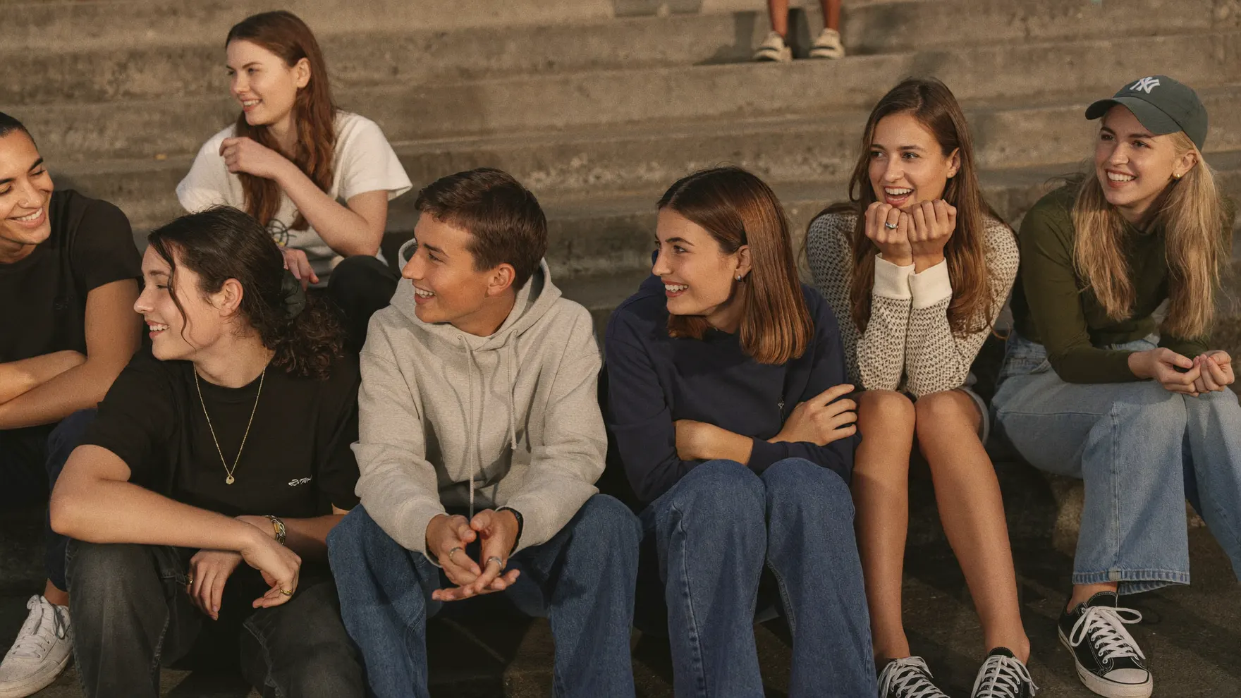 A group of young people laughing together outdoors