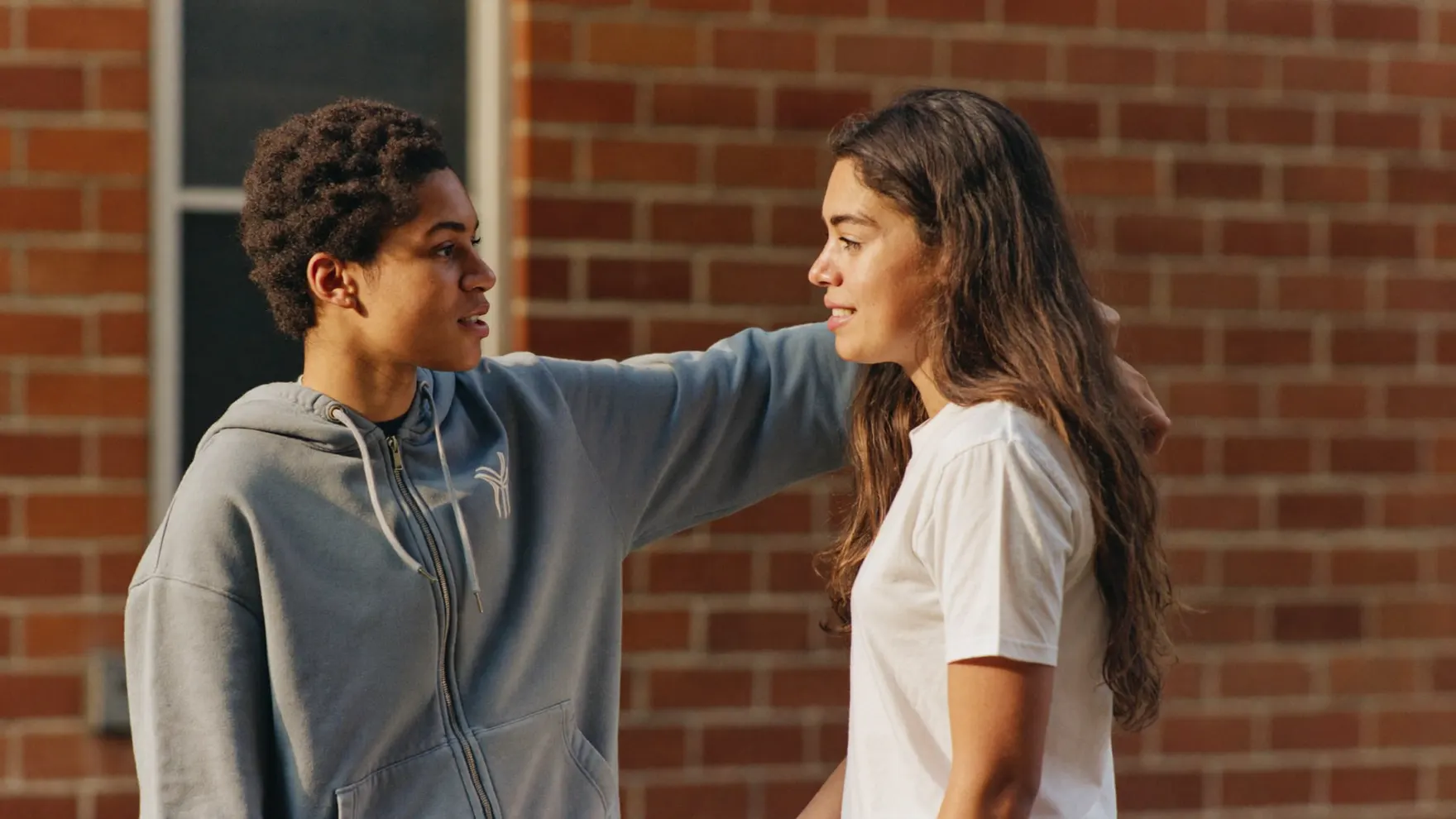 Two young people talking openly outside