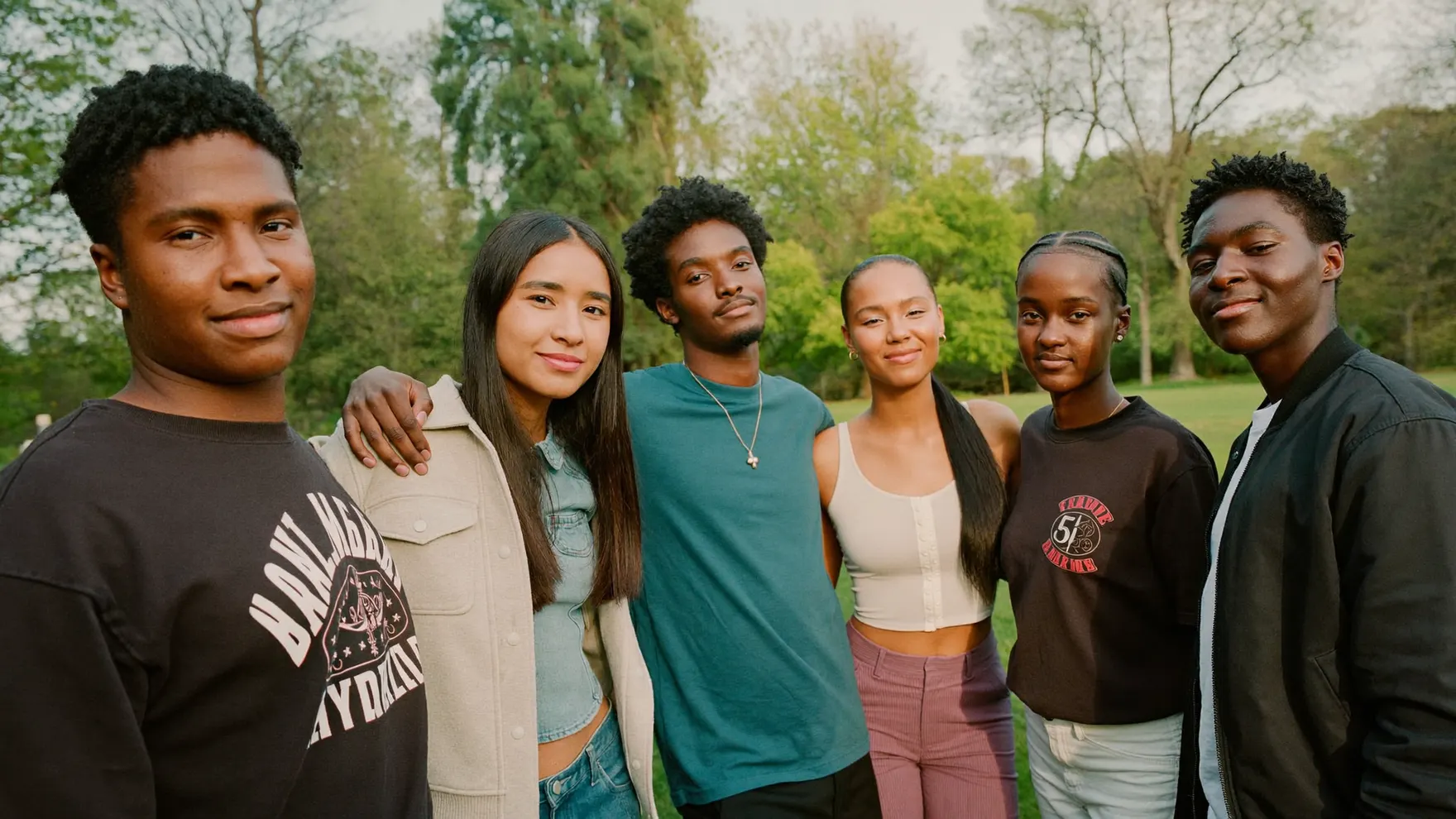 A group of young people standing together outdoors